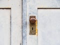 Old wooden door with a rusty round handle