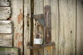 Old Wooden Door With A Rusty Steel Lock. Farm Gate From Planks With An Old Padlock. The Lock On The Door Of The Shed Royalty Free Stock Photo