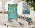 Old wooden door of a shabby demaged house facade or front.