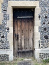 an old wooden door on a stone built building Royalty Free Stock Photo