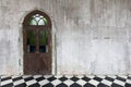 Old wooden door on a stone concrete cement wall background.