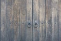 Old wooden door in the stone wall from medieval era. Vintage metal padlock on a wooden door. Royalty Free Stock Photo