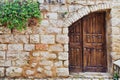 Old wooden door in a stone wall Royalty Free Stock Photo