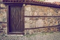 Old wooden door in the stone wall Royalty Free Stock Photo