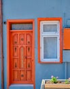 Old wooden door, tiny concept wall and orange color Royalty Free Stock Photo