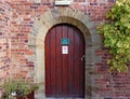 Old wooden door to disabled toilets at Arley Arboretum in the Midlands in England Royalty Free Stock Photo