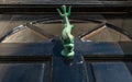 Old wooden door to house with a brass knocker in the shape of a Royalty Free Stock Photo