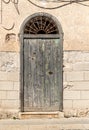 Old wooden door of the typical ancient mediterranean stone house in Sicily Royalty Free Stock Photo