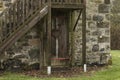 Old wooden door under a stairway outdoors Royalty Free Stock Photo