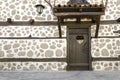 Old wooden door and White stone wall Royalty Free Stock Photo