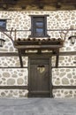 Old wooden door with White stone wall Royalty Free Stock Photo