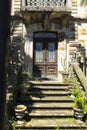 Old wooden door with white wrought details