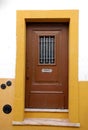 Old wooden door in white and yellow house Royalty Free Stock Photo