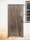 The old wooden door with the wood latch on the white wall Royalty Free Stock Photo