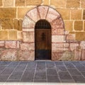 Old wooden door with wrought iron details Royalty Free Stock Photo