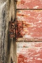 Old wooden door with wrought iron details and rusty hinge Royalty Free Stock Photo