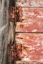 Old wooden door with wrought iron details and rusty hinge Royalty Free Stock Photo