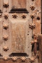 Old wooden door with wrought iron details stair shaped Royalty Free Stock Photo