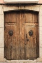 Old wooden door with wrought iron door knockers