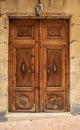 Old wooden door with wrought iron door knockers Royalty Free Stock Photo