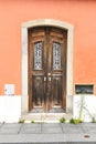 Old wooden door with wrought iron door knockers