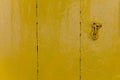 old wooden door in yellow. painted wood texture. part of the door chain. background for your company Royalty Free Stock Photo