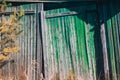 Old wooden doors of an abandoned house. The rickety green wooden gate. Abandoned village Royalty Free Stock Photo