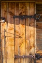 Old wooden doors closed on padlocks. Doors with forged metal elements Royalty Free Stock Photo