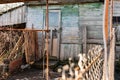 Old wooden doors on a collapsing building, a vintage barn, peeling paint, littered planks Royalty Free Stock Photo