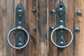 Old wooden doors. Iron rings on the gate. Decoration elements of buildings, vintage iron door handles, knockers and gong handle Royalty Free Stock Photo