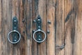 Old wooden doors. Iron rings on the gate. Decoration elements of buildings, vintage iron door handles, knockers and gong handle Royalty Free Stock Photo