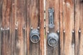 Old wooden doors with metal door handle, knocker. Wooden doors with metal hardware Royalty Free Stock Photo