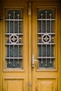 Old wooden doors with original metal bars on the windows. Royalty Free Stock Photo