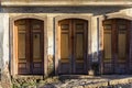 Old wooden doors spoiled by time on the facade of a colonial style house Royalty Free Stock Photo