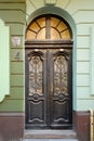 Old wooden doors with stained-glass windows, forged grills and ornaments Royalty Free Stock Photo