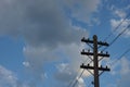 Old wooden electric pole on a blue cloudy sky background Royalty Free Stock Photo
