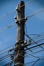 Old wooden electric pole in wires. Royalty Free Stock Photo