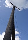 Old wooden electricity pole, wires, blue sky Royalty Free Stock Photo