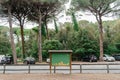 Old wooden empty green board for local announcements on the street of the Italian village