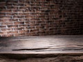 Old wooden empty table and brick wall in the background Royalty Free Stock Photo