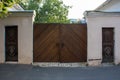 Old wooden entrance gate with iron handles. On each side - two additional small input wooden gates. The architecture of the 18th c