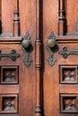 Old wooden exterior doors with decorative panels, brass doorknobs