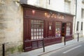 Old wooden facade of a small old cafe on the street of the Latin quarter of Paris