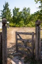 Old wooden farm gate structure open to farmyard in ethnographic open-air museum in Pyrohiv, Ukraine