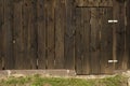 Old wooden farm rural building doors locked with. Background of old architecture. Dark old wood. Royalty Free Stock Photo