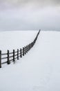 Old wooden farme fence in a winter rural landscape Royalty Free Stock Photo