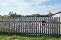 Old wooden fence against a blue sky with clouds on a sunny day Royalty Free Stock Photo