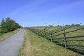 An old wooden fence around a field with meadow flowers on Kizhi Island in Karelia