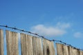 Old wooden fence with barbed wire Royalty Free Stock Photo