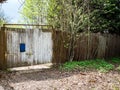 old wooden fence with closed shubby wooden gate Royalty Free Stock Photo